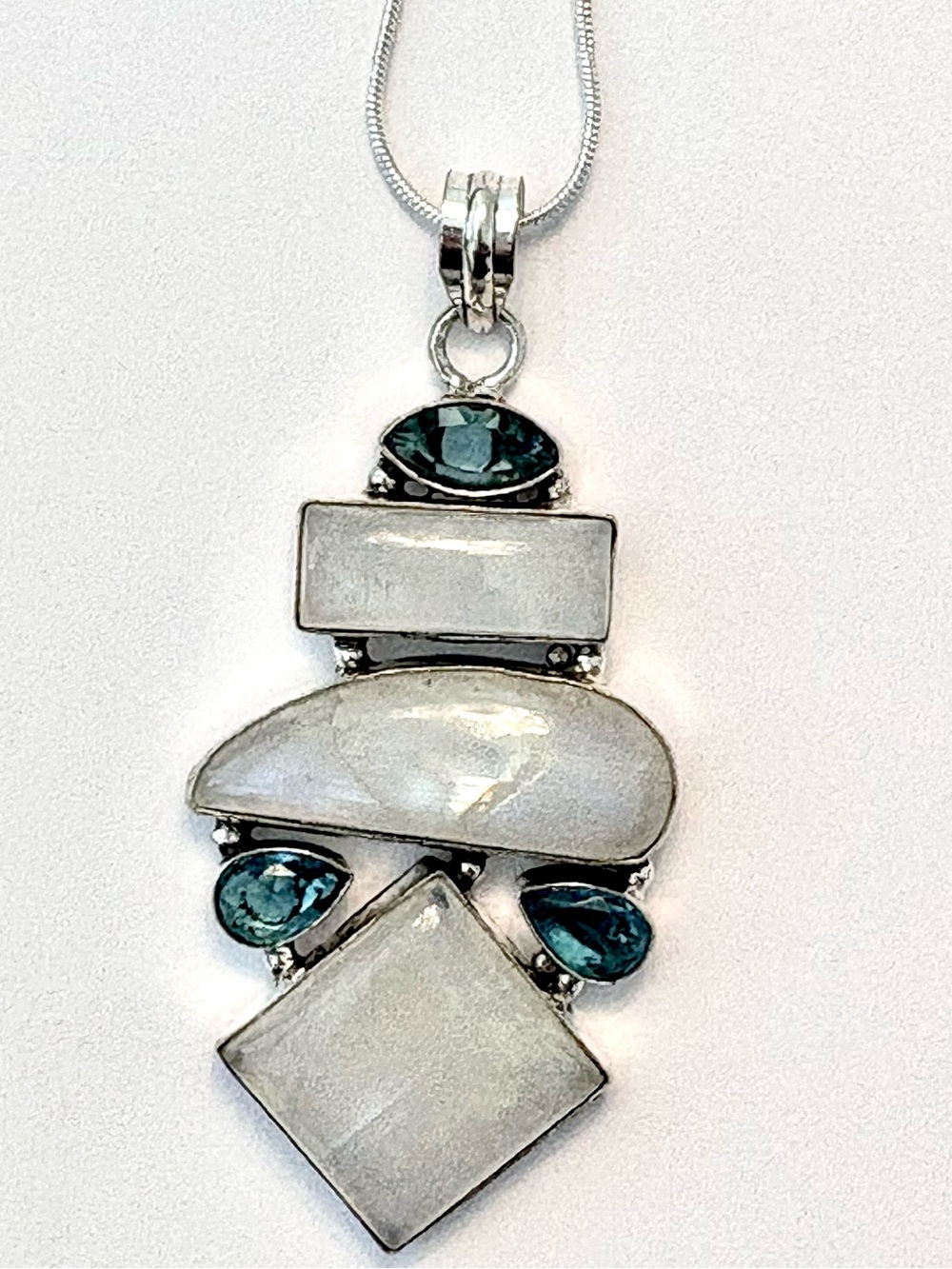 3 inch, 925 marked, 3 Rainbow Moonstone, and 3 Blue Topaz on a silver chain.